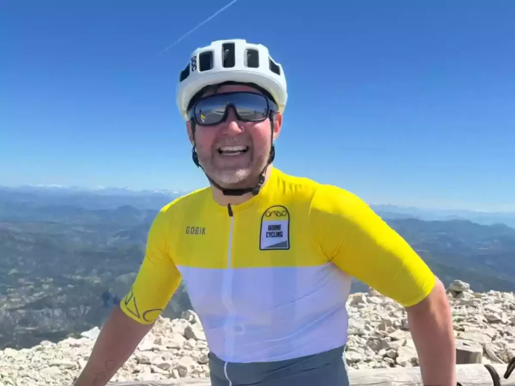 Paul Munn in Borne Cycling jersey on a blue sky day at the top of Mont Ventoux