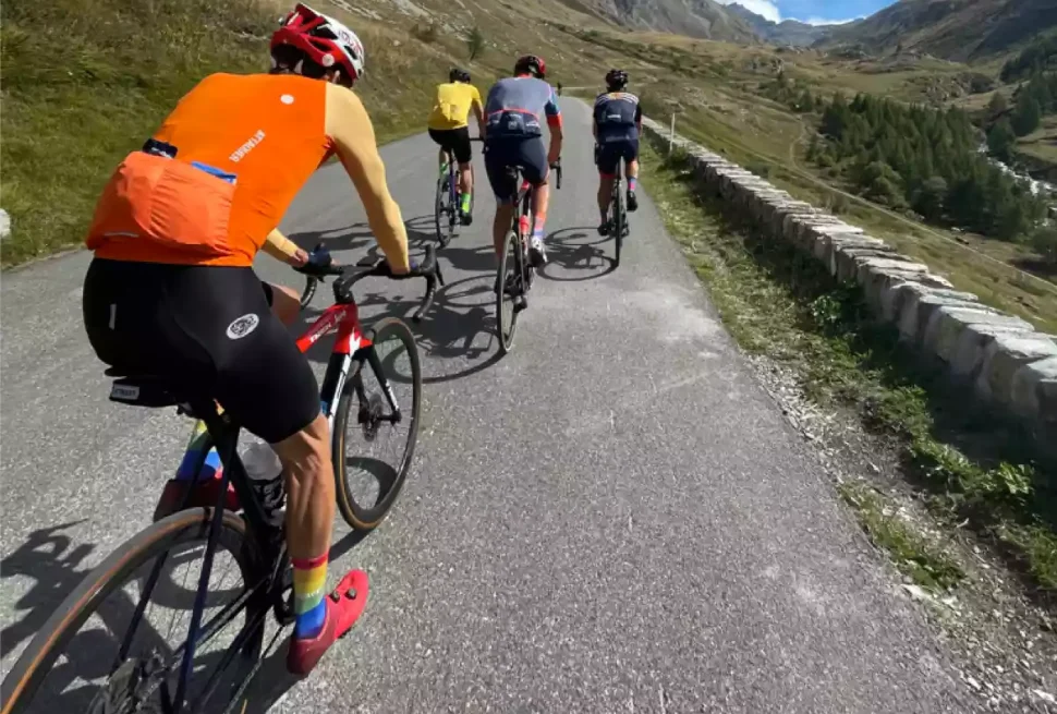 group of cyclists riding on col d'iseran