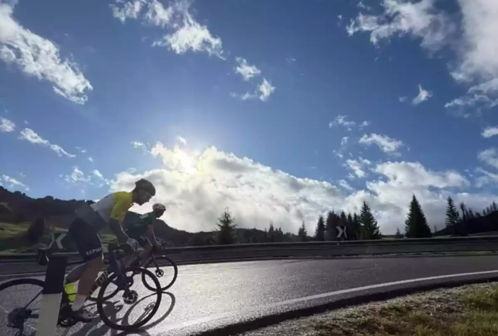 cyclists on passo campolongo at sunrise